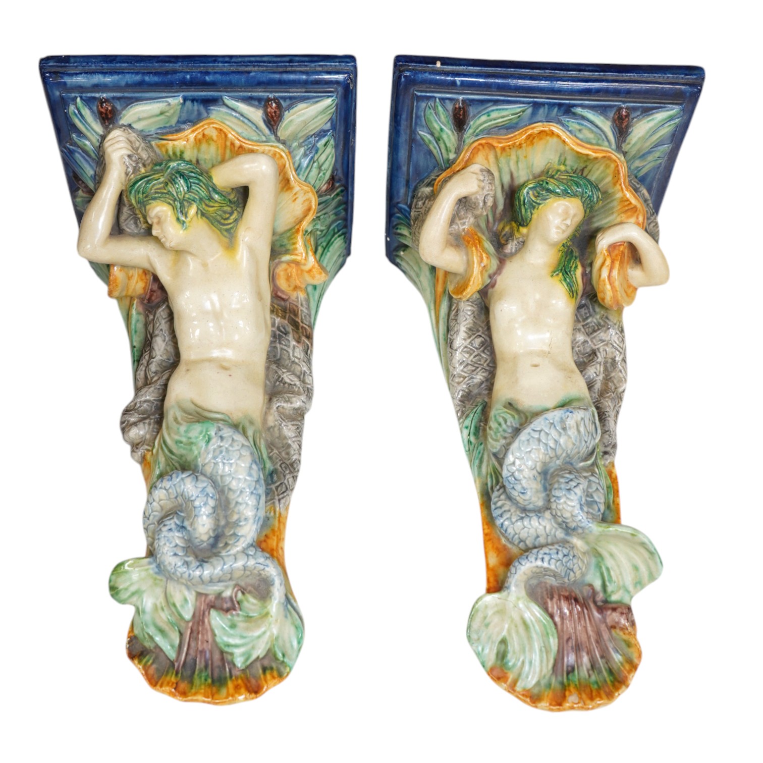 A pair of late 19th century Continental majolica ‘mer people’ wall brackets, 30cm. Condition - fair to good